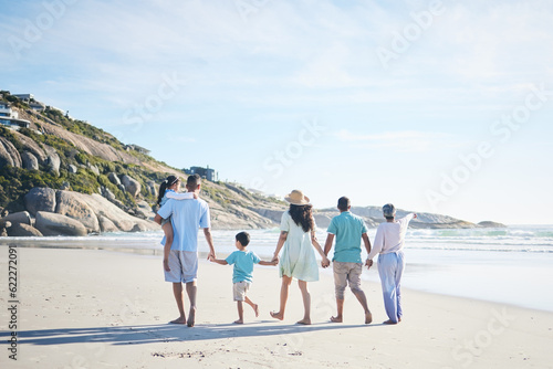 Beach, holding hands and grandparents, parents and kids for bonding, quality time and relax in nature. Family, travel and mom, dad and children walking by ocean on holiday, vacation and adventure