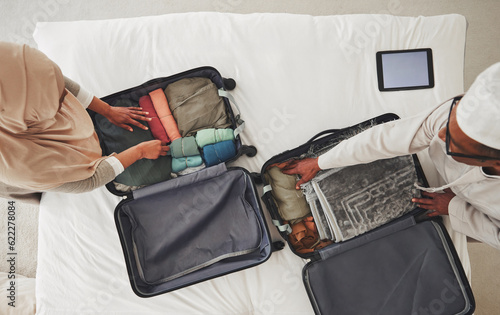 Travel, bedroom and Muslim couple with suitcase packing for holiday, vacation and religious trip. Home, luggage and above of man and woman with clothes in bag for journey, adventure and tourism