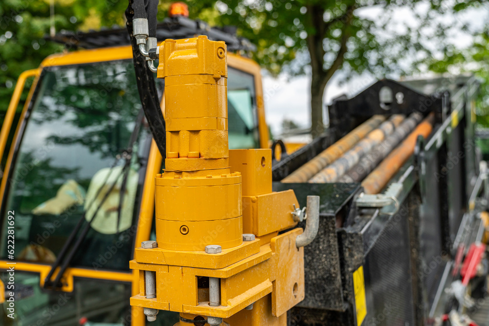 Close up of the yellow hydraulic part of the earth-moving machine. Close up of the yellow hydraulic part of the earth-moving machine.