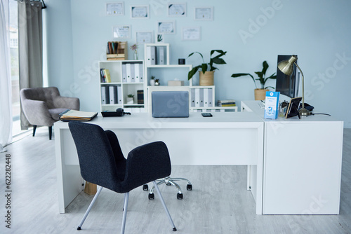 Empty, office of medical doctor and consultation with furniture, table or professional layout of hospital interior. Background, consulting room or workplace in healthcare, surgery and wellness clinic