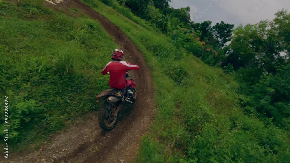 Dynamic chase motocross track moto riding red equipment male speed race turn on winding sand dirt path countryside aerial view. FPV sport drone motorbike speed adrenaline ride offroad trail extreme 4k Dynamic chase motocross track moto riding red equipment male speed race turn on winding sand dirt path countryside aerial view. FPV sport drone motorbike speed adrenaline ride offroad trail extreme 4k