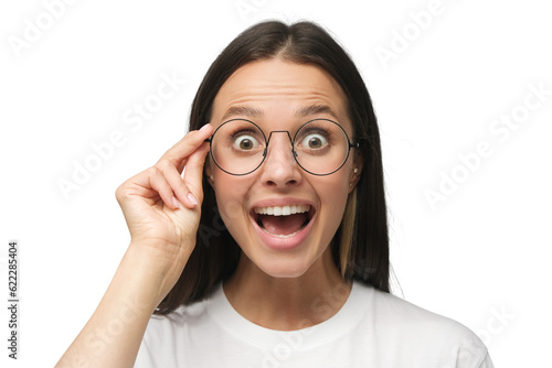 Young woman in white t-shirt shouting oh my god with open mouth, surprised by low price and sales, holding glasses photo