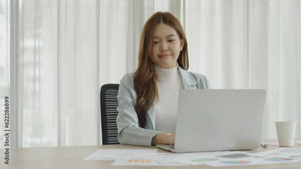 Asian business woman working on laptop and her paperwork in the office. Asian business woman working on laptop and her paperwork in the office.