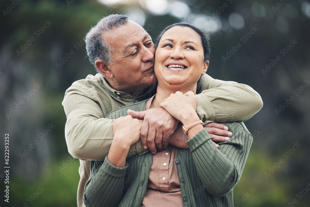 Hug, kiss and senior couple in nature, thinking and love during retirement together. Happy, idea and an elderly man and woman with affection in a garden or park for support or care in marriage