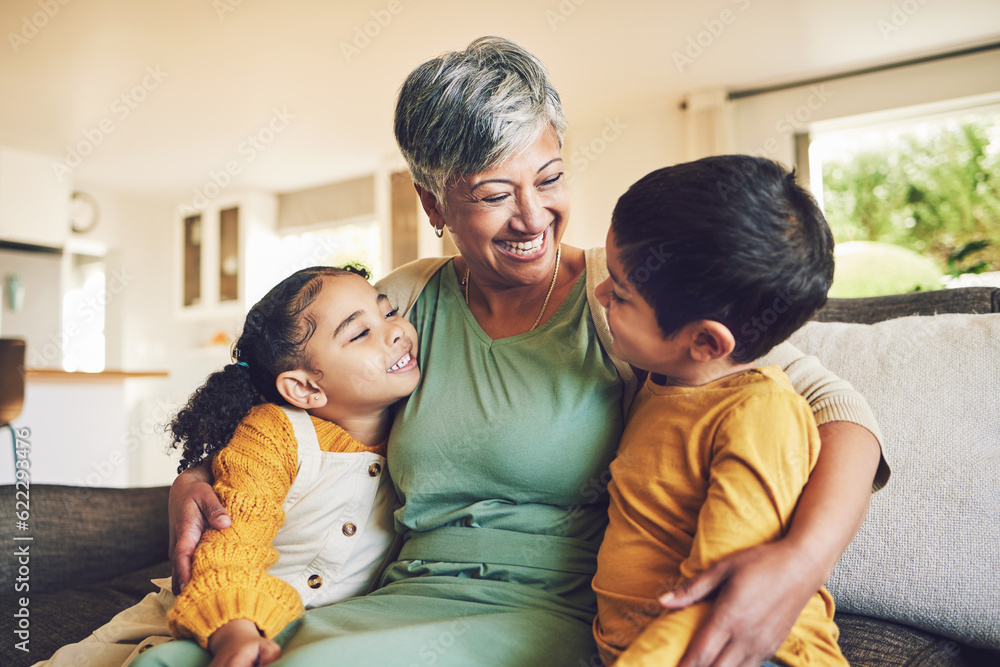 © Azee/peopleimages.com - Hug, grandmother or happy kids on a sofa with love enjoying quality bonding time together in family home. Smile, affection or funny senior grandparent with children siblings on house couch laughing