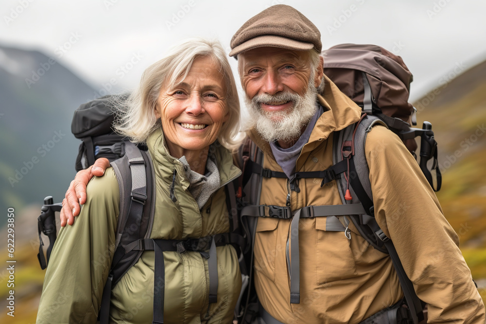 Active retired couple hiking outdoors in mountains in fall