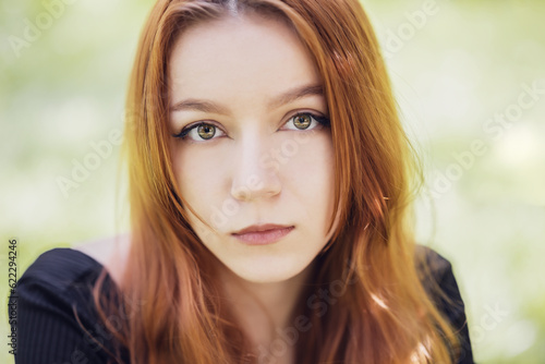 Portrait of beautiful young redhead woman with red hair.