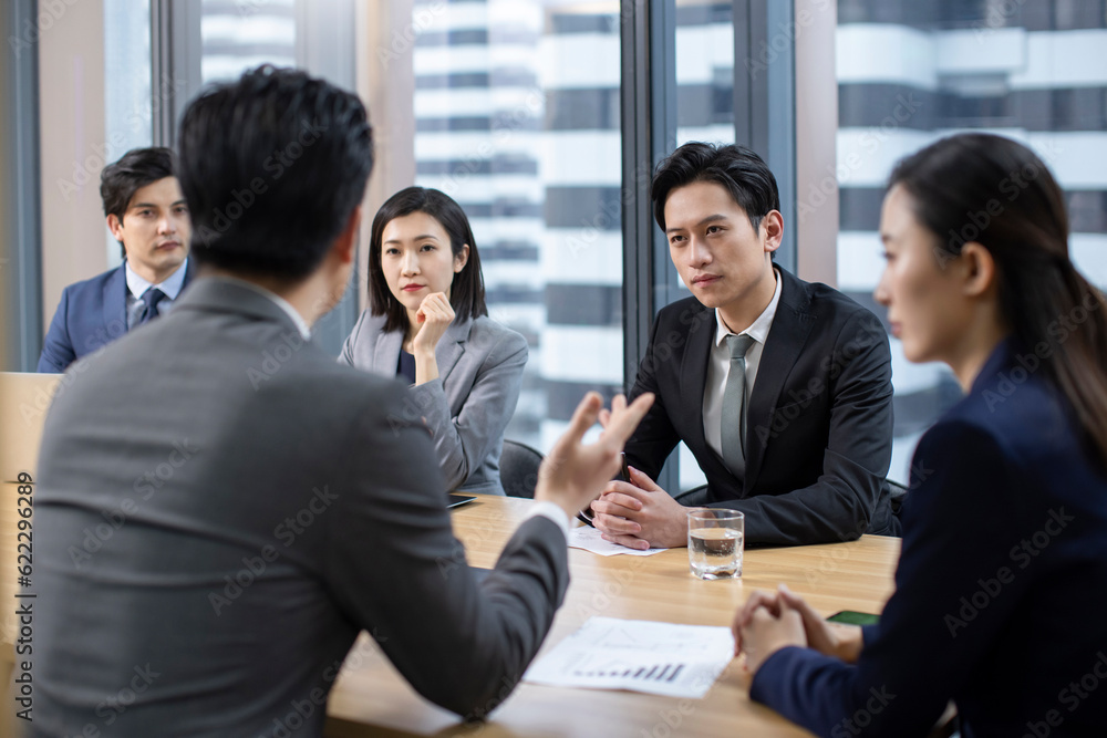 Confident Chinese business people having a meeting Confident Chinese business people having a meeting