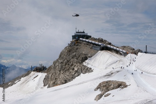 The upper station of cable car on top of Hunerkogel (2700 m above sea level) and helicopter on station building. photo