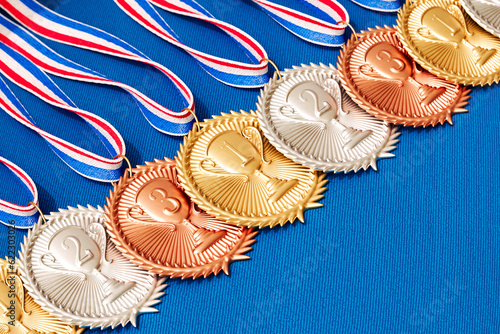 Beautifully Decorated Medals on Blue Fabric Background for Awards or competition