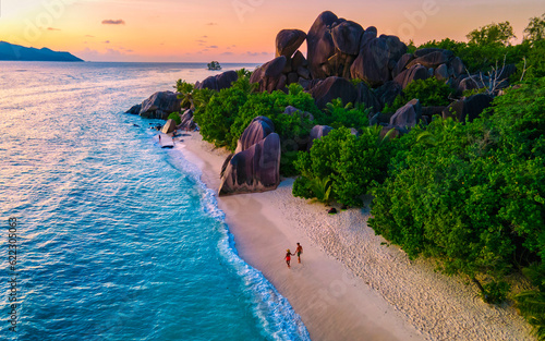 Anse Source d'Argent, La Digue Seychelles, a young couple of men and women on a tropical beach during a luxury vacation in Seychelles. Tropical beach Anse Source d'Argent, La Digue Seychelles