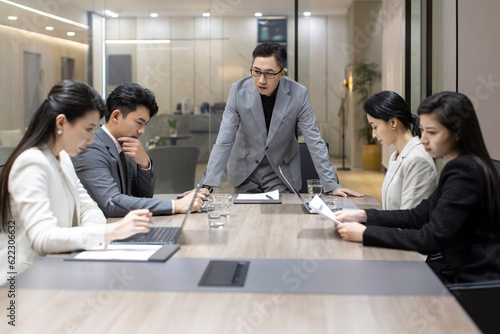 Chinese business people having a meeting in meeting room photo