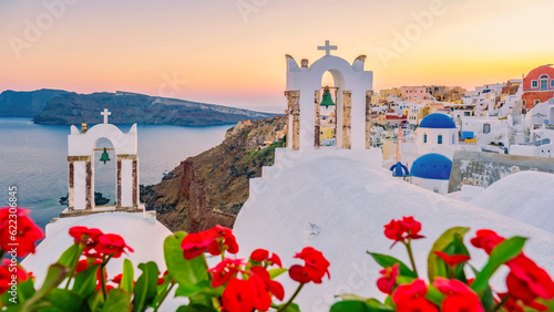 Fototapeta Naklejka Na Ścianę i Meble -  Sunset at the Island Of Santorini Greece, beautiful whitewashed village Oia with the church during sunset, streets of Oia Santorini during summer vacation at the Greek Island