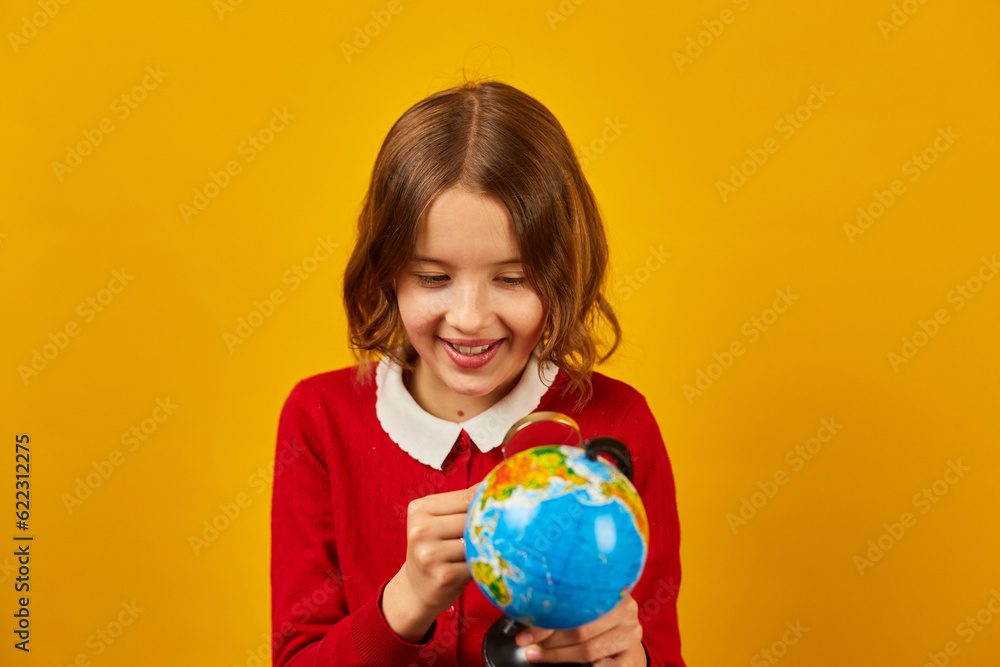 Stylish smiling school teenage girl holding magnifying glass in her hand Stylish smiling school teenage girl holding magnifying glass in her hand