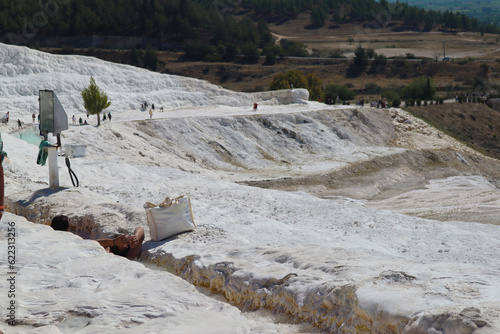 Tourist enjoy sunbathing and soaking on Water flow at cotton castle pamukkale. photo