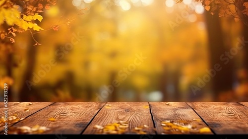 Empty wooden table top with autumn leaves background
