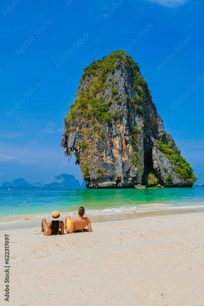 Fototapeta premium a couple of men and women on the beach of Railay Krabi Thailand, Panoramic view of idyllic Railay Beach in Thailand