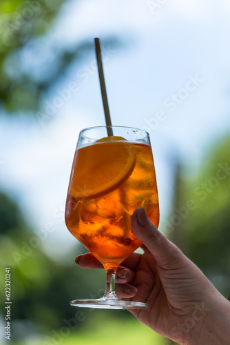 hand holding a glass of cocktail