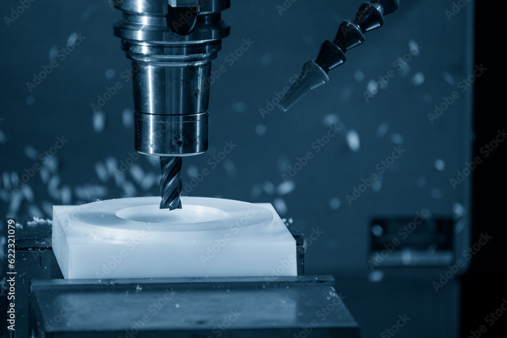 The CNC milling machine cutting the nylon 6 material part with flat end mill tool. The CNC milling machine cutting the nylon 6 material part with flat end mill tool.
