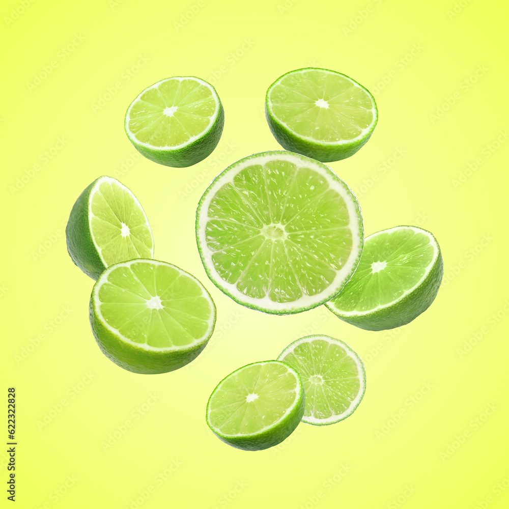 Fresh lime fruits falling on green yellow background