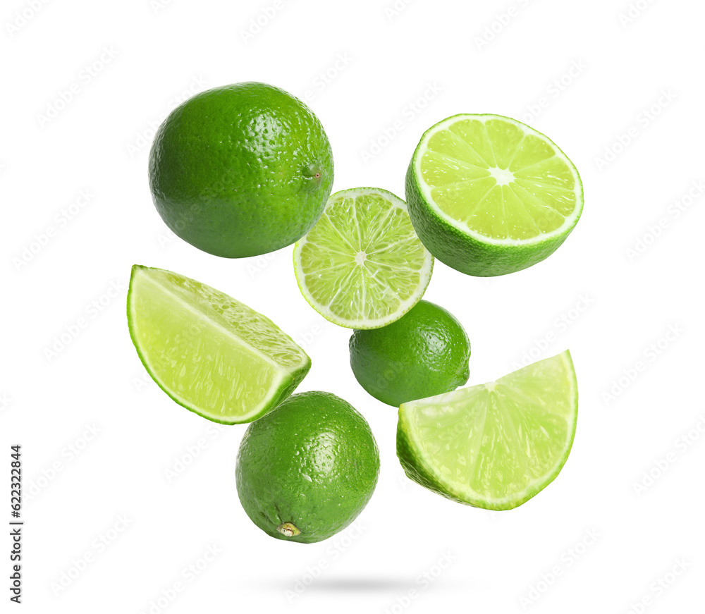 Fresh lime fruits falling on white background
