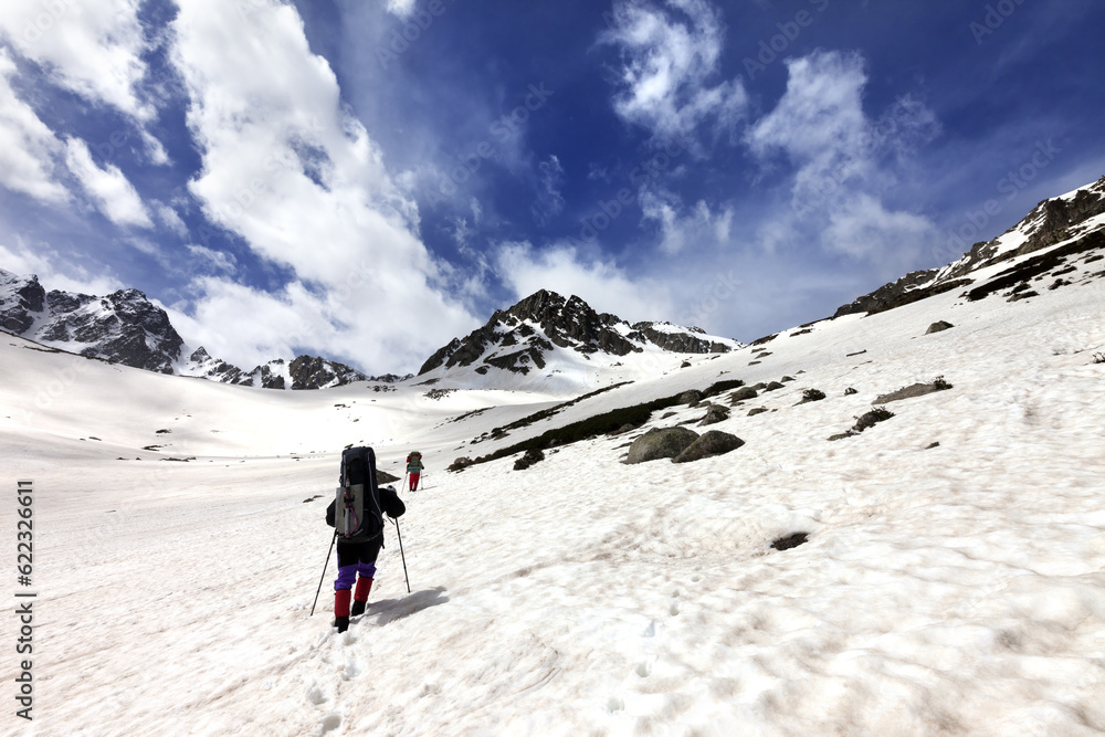 Two hikers in snow plateau. Turkey, Kachkar Mountains, highest part of Pontic Mountains. Wide angle view.