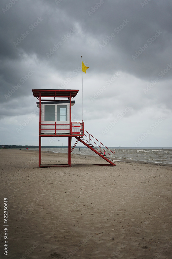 A lifeguard tower on an empty sea beach on a gloomy autumn day A lifeguard tower on an empty sea beach on a gloomy autumn day