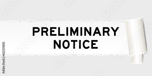Ripped gray paper background that have word preliminary notice under torn part