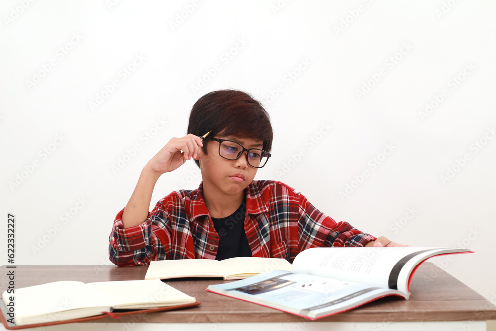 Confused asian student thinking an idea while studying. Isolated on white Confused asian student thinking an idea while studying. Isolated on white