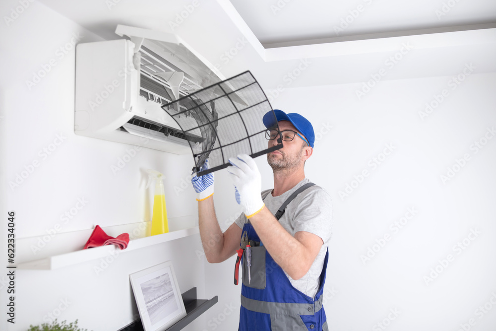 Service guy cleaning and maintaining air condition unit. Service guy cleaning and maintaining air condition unit.