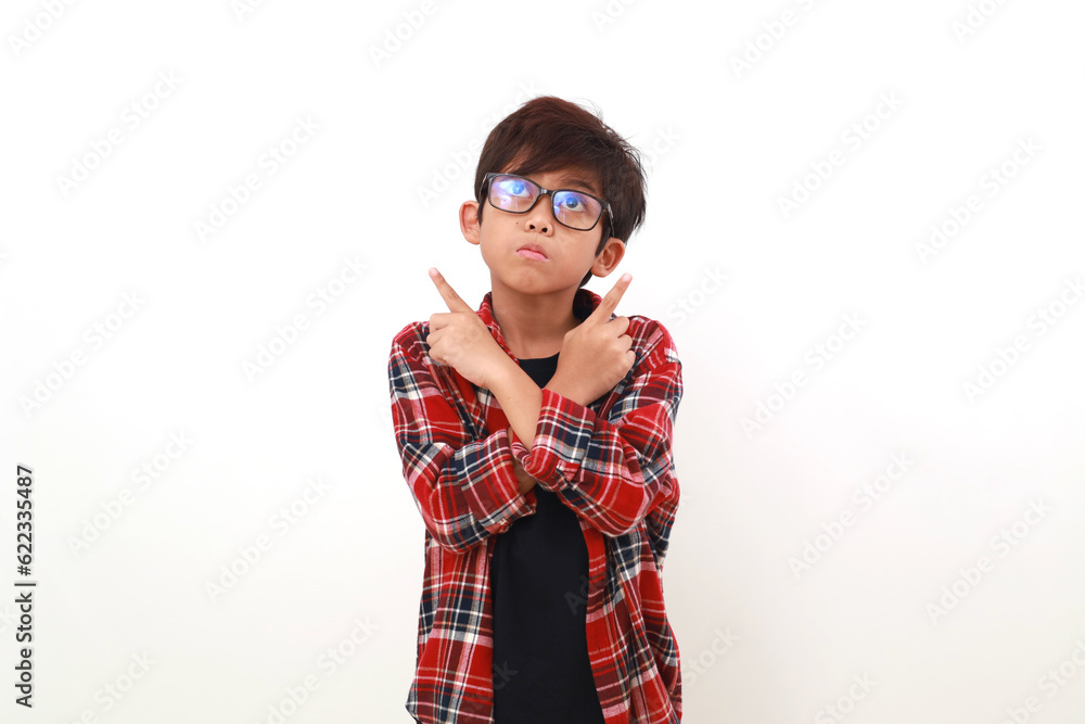 Confused asian boy standing while pointing between two choice. Isolated on white Confused asian boy standing while pointing between two choice. Isolated on white