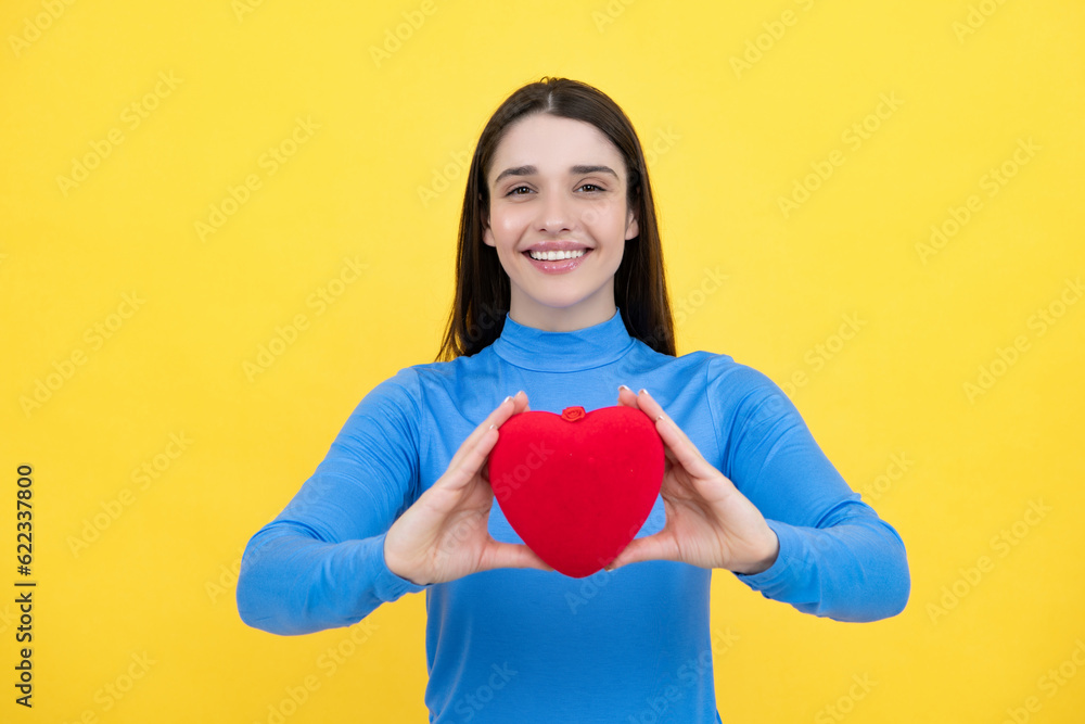 Beautiful amazing woman cuddle paper card heart shape, dreamy isolated on yellow background. Love concept. Beautiful amazing woman cuddle paper card heart shape, dreamy isolated on yellow background. Love concept.
