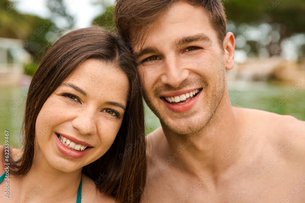 Fototapeta premium Portrait of a young couple embraced inside the pool