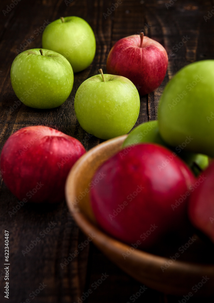 Green and red organic apples in bowl on wooden board. Healthy food Green and red organic apples in bowl on wooden board. Healthy food