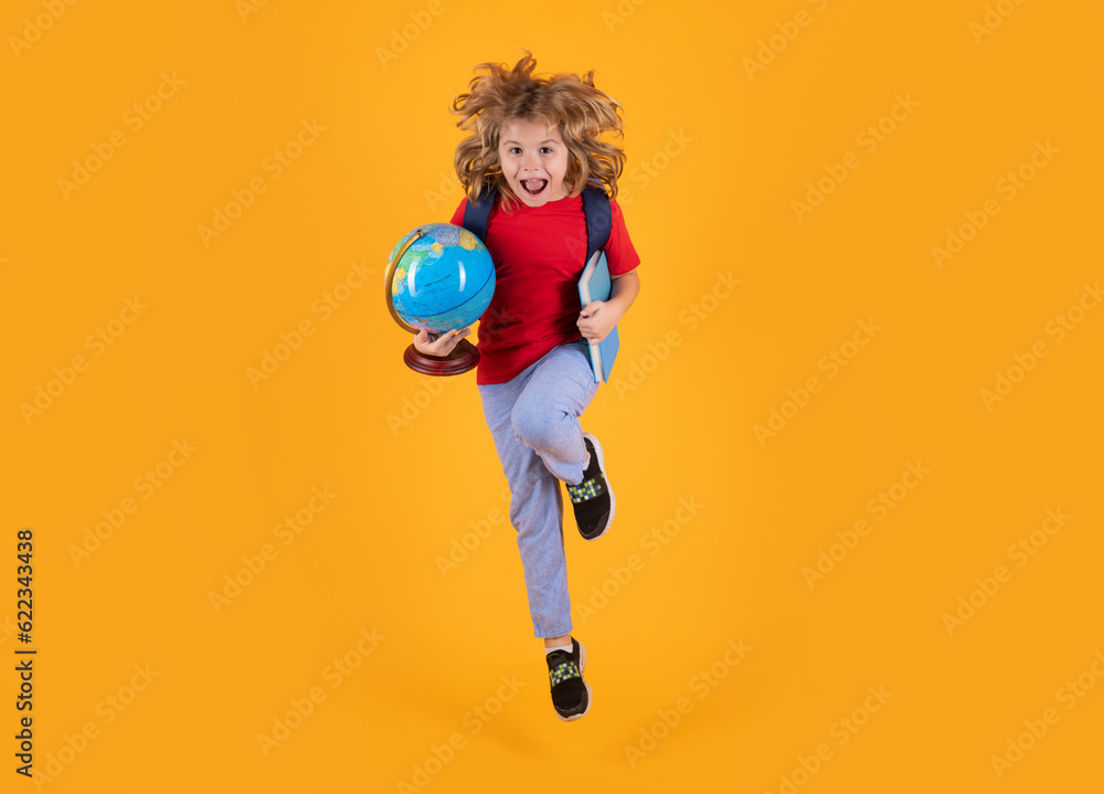 Back to school. Photo of excited little school jumping holding book ...