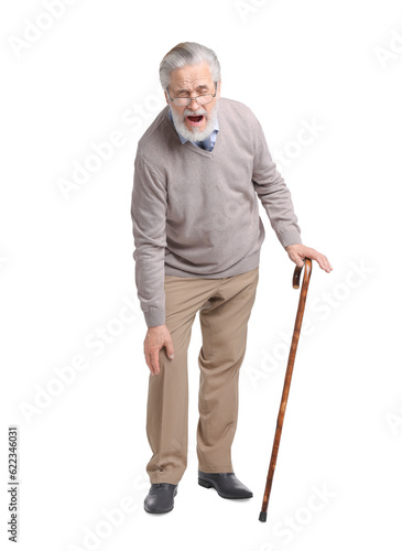 Senior man with walking cane suffering from knee pain on white background © New Africa