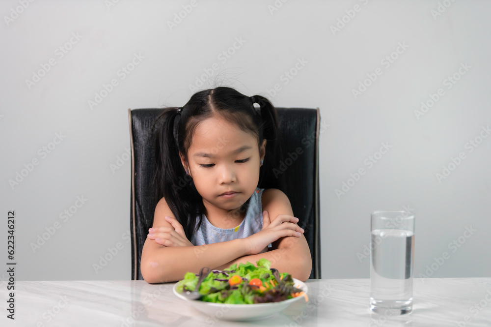 Little asian cute girl refuses to eat healthy vegetables.Nutrition ...