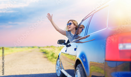 Beautiful blonde woman driving a car. Young woman in a car.