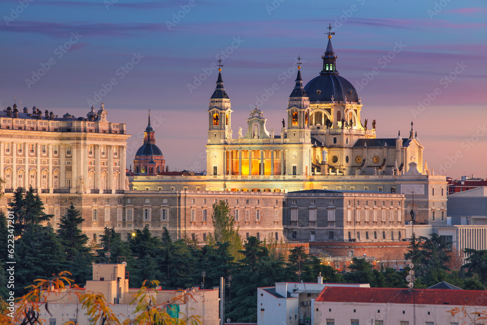 Image of Madrid skyline with Santa Maria la Real de La Almudena Cathedral and the Royal Palace during sunset.