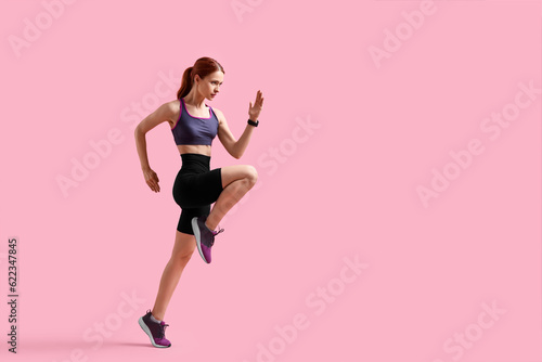Young woman in sportswear running on pink background, space for text