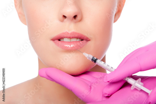 Beautiful plump lips injection with collagen filler Cosmetic spa beauty treatment with pink gloves, on white.