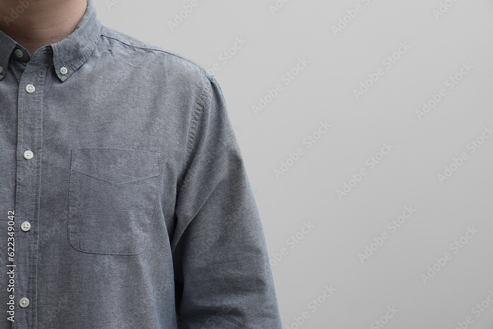 Man wearing clean shirt on white background, closeup. Space for text Man wearing clean shirt on white background, closeup. Space for text