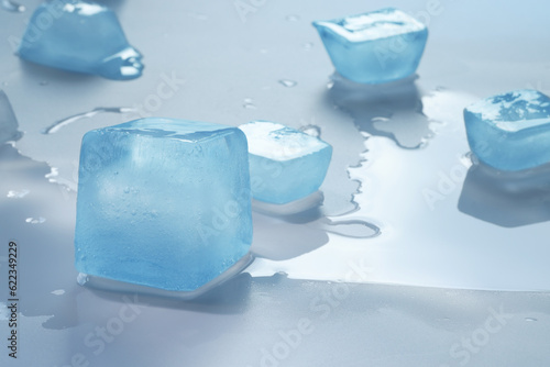 Crystal clear ice cubes on light blue background