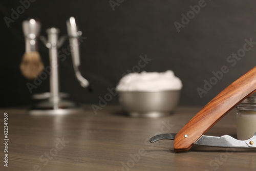 Wooden straight razor on table, closeup. Space for text
