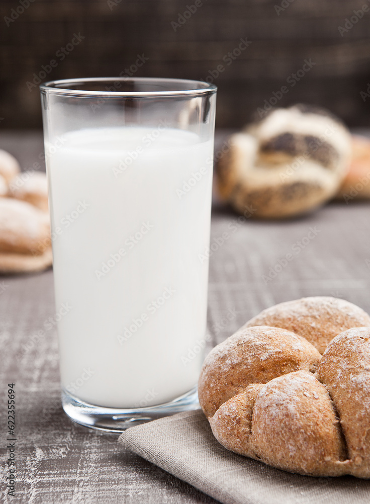 Glass of milk with bread roll for breakfast morning Glass of milk with bread roll for breakfast morning