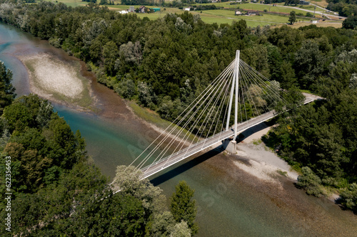 White catwalk suspended in the middle of Swiss nature. No one on it walking or cycling. View from above, taken with drone. Below you can see the river.