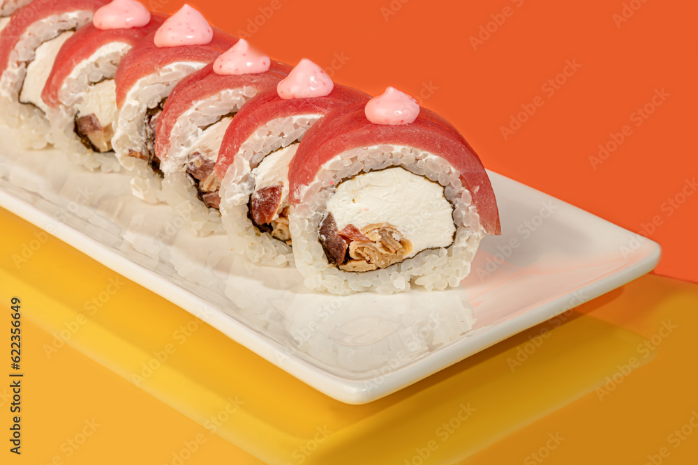 Sushi sets, rolls with caviar, shrimp, tuna and avocado and Philadelphia cheese, on a white plate. Sushi sets, rolls with caviar, shrimp, tuna and avocado and Philadelphia cheese, on a white plate.