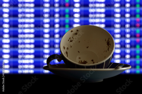 Stock forecast, illustrated by reading tea leaves (Tasseography) in front of trading screen
