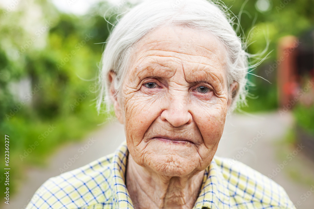 Portrait of an aged woman smiling outdoors Portrait of an aged woman smiling outdoors