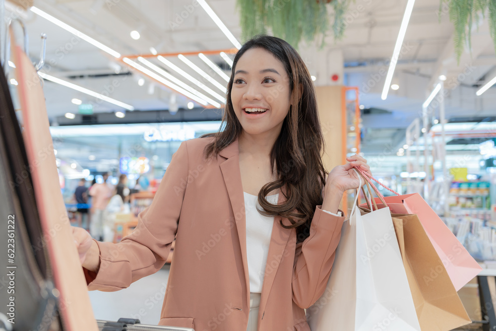 Modern happy asian Female lifestyle fashion portrait. beautiful attractive young woman girl enjoy stylish walk with shopping bag packages on the street, trendy outfit on shopping mall, browse product. Modern happy asian Female lifestyle fashion portrait. beautiful attractive young woman girl enjoy stylish walk with shopping bag packages on the street, trendy outfit on shopping mall, browse product.